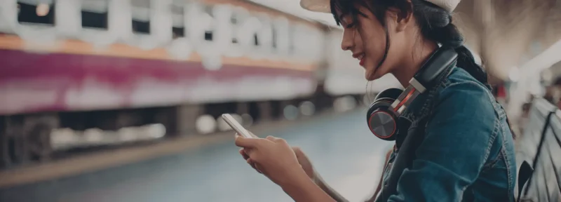 A young woman holding a cellphone