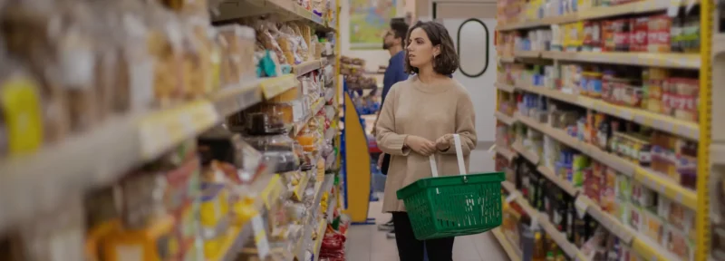 Young women looking at items in a grocery store aisle